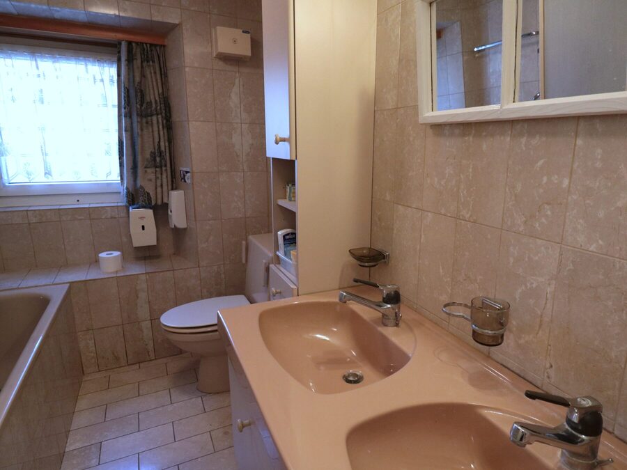 Badezimmer mit Badewanne, WC und Doppelwaschtisch